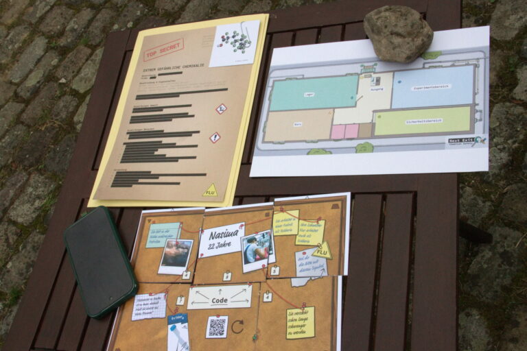 Escape Game Material Chemical Safty Tisch IMG 6414.CR2 Spielmaterialien des Spiels auf einem Tisch ausgelegt